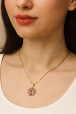 Golden flower locket with pink stone