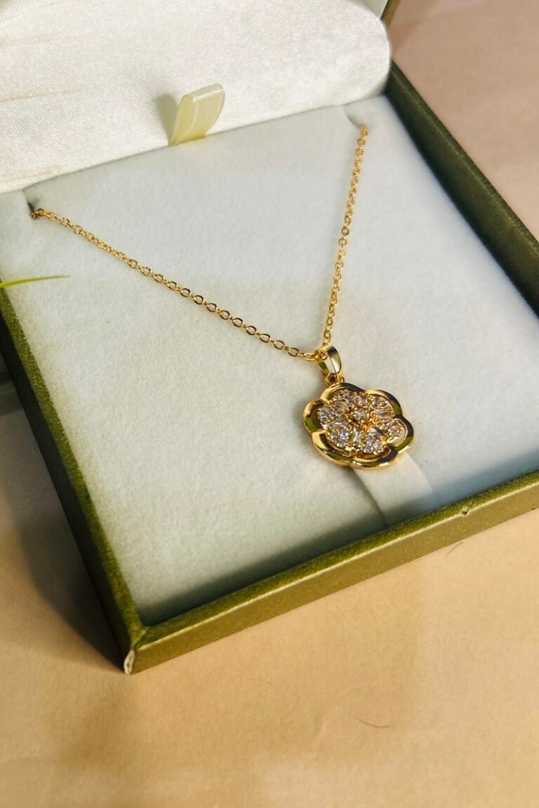 Golden flower locket with silver stone