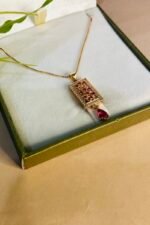 Golden rectangle shape locket with pink stone