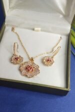 Flower golden locket set with dark pink stone